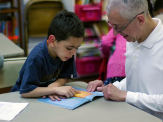Young boy in Robert Bowne Foundation funded afterschool program with mentor