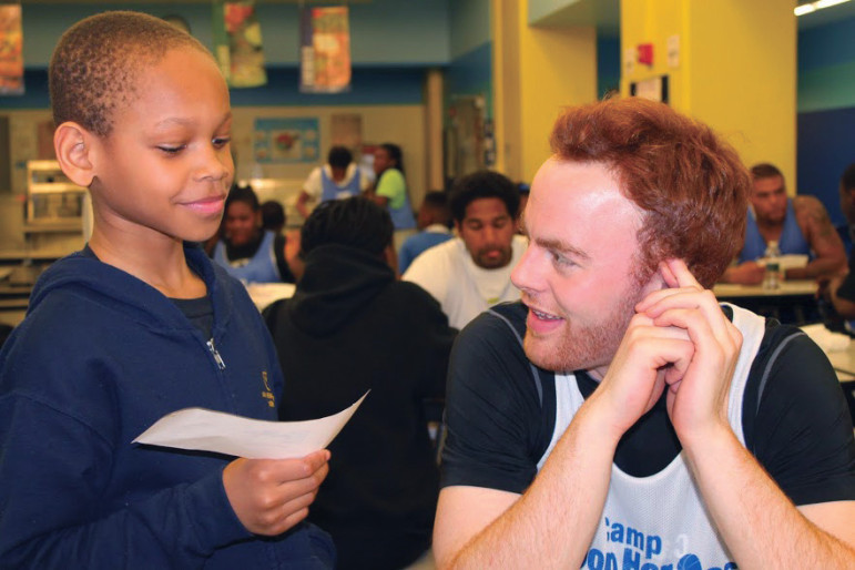 A volunteer mentor for After-School All-Stars chats with a student in New York City.