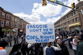 People gather Tuesday, April 28, 2015, in Baltimore, in the aftermath of rioting following Monday's funeral for Freddie Gray, who died in police custody.