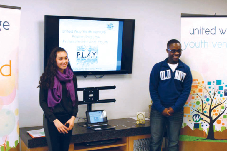 Laura Jenny (left) and Isaac Annan present their idea to United Way Youth Venture, promoting a new way to educate their peers about interacting safely with local police.