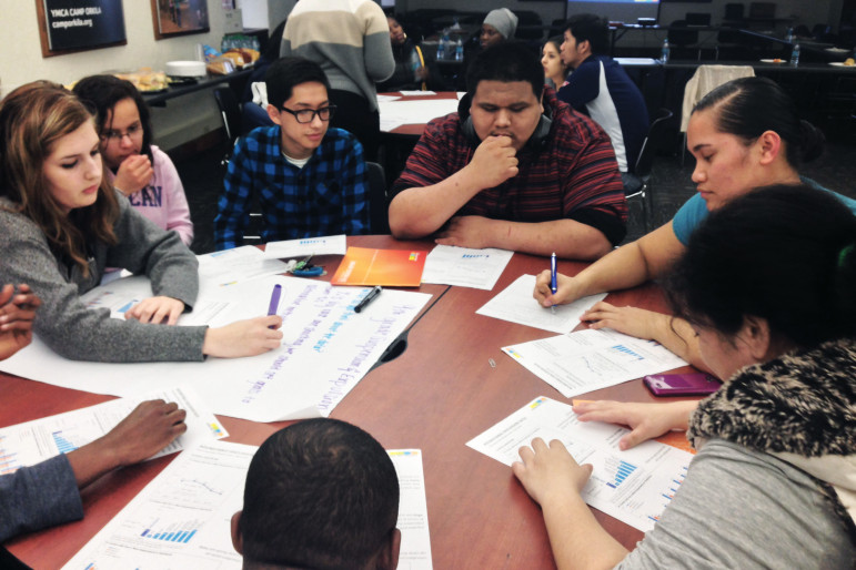 Members of the Opportunity Youth Advisory Group for the Road Map Project in Seattle analyze school discipline data. The advisory group helps guide the project in building systems to reconnect young people to school and living-wage work. Second from right is Freda Crichton.