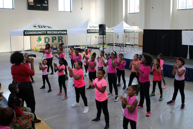 Students in the D.C. Department of Parks and Recreation's after-school pom-poms program debut a new routine to kick off the Lights On Afterschool event on Thursday at Raymond Recreation Center.