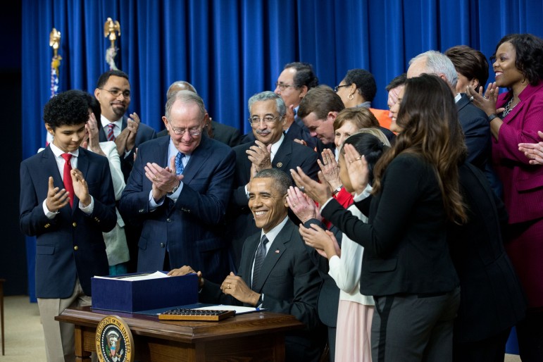 President Obama signs Every Student Succeeds Act.