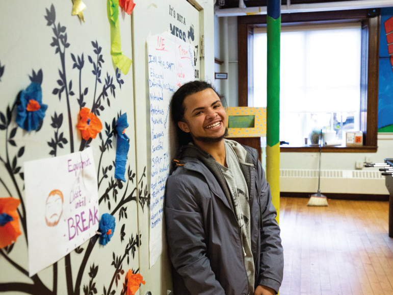 Santiago Andino poses at UTEC headquarters in Lowell, Massachusetts. Andino is being mentored by UTEC staff.