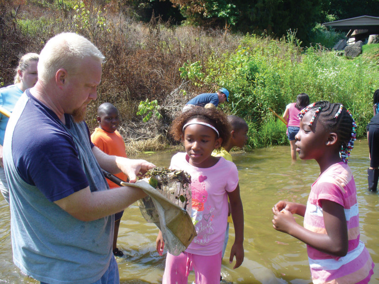 Students in Spring Hill, Tennessee, work with the Tennessee Environmental Council, looking at macroinvertebrates in their local river.