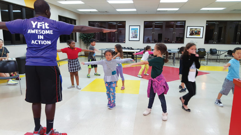 Youth Wellness Specialist Aaron Pierre leads children in fun physical activity as part of the YFit program at Pembroke Pines Family Center in South Florida.