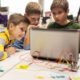k-12 education grant, youth with laptop doing project