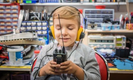 youth amateur radio grants; child with headphones and radio