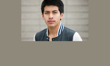 Report Noncitizen-youth-latino-male-teen-headshot-in-denim-jacket
