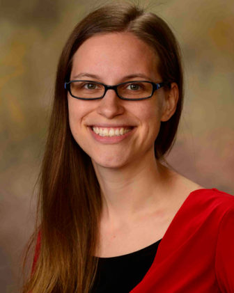 Rebecca Fix (headshot), assistant scientist at Johns Hopkins Bloomberg School of Public Health, smiling woman with long, light brown hair, glasses, red top over black.