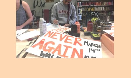 Protest Signs: Teen student protesters paint signs "NEVER AGAIN" preparing to march .