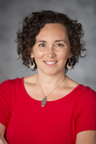 Stephanie Malia Krauss (headshot), director of special projects at Jobs for the Future, smiling woman with short, brown curly hair, earrings, necklace, red top