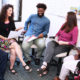 educator support project grants: Five educators discussing teen writing, smiling educators in a group with white board in background