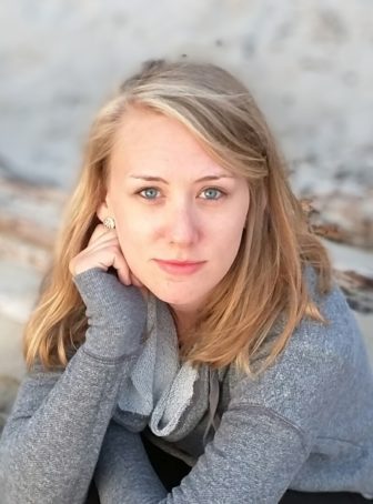 Erin Heinitz (headshot), blonde wearing gray top.