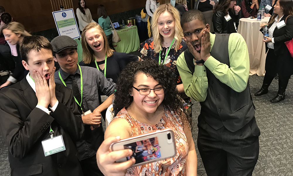 Afterschool Alliance: 6 young people wearing lanyards and IDs make faces as they pose for a selfie.