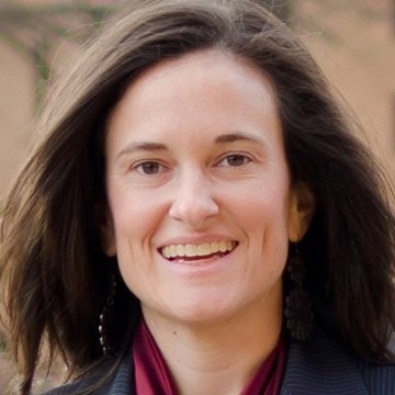 AnnMarie Schultz (headshot), chief executive officer of CORA Services, smiling woman with medium-length brown hair, dark jacket, red top.