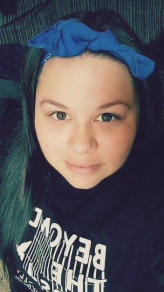  Alyssa R., 21 (headshot), is youth mentor, Christian camp staff member from Los Angeles, serious-looking young woman with long dark hair, blue headband, dark sweatshirt.