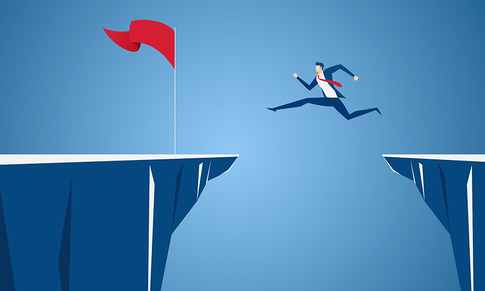 Uncertainty: Businessman jump through the gap obstacles between hill to red flag and success.