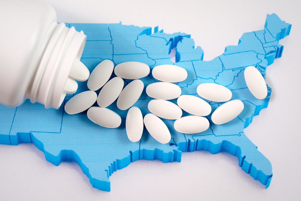 Foster care: White prescription pharmaceutical pills on map of United States