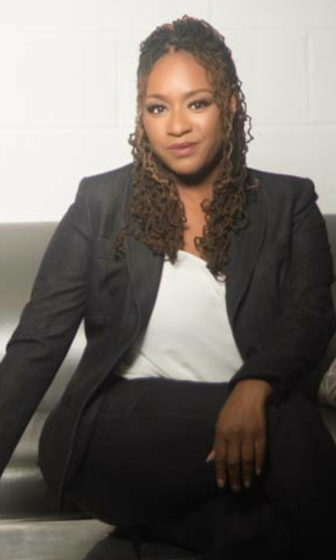 Youth leaders: Pamela Larde (headshot), associate professor of research at Mercer University, woman with long curly hair wearing black jacket and pants, white top.