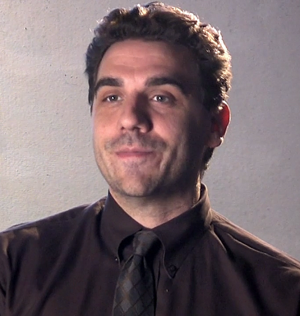 Frank Baiocchi headshot in dark dress shirt and tie