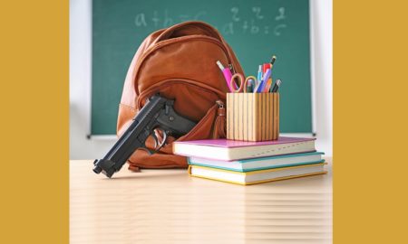 backpack, school supplies and gun in classroom