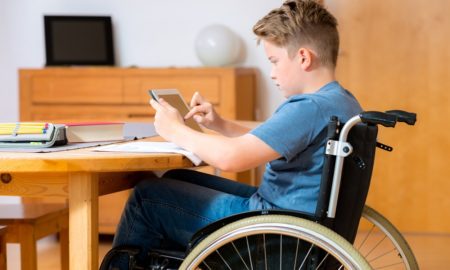 disabled boy doing homework on ipad