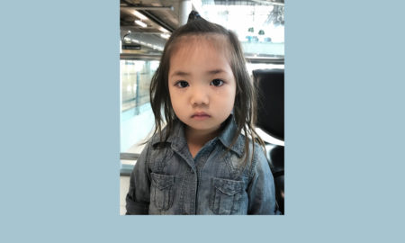 immigration: Adorable toddler baby with Jeans shirt crying and expressions of sadness. Little asian cute girl with in the eyes visible tears sitting in the airport international.