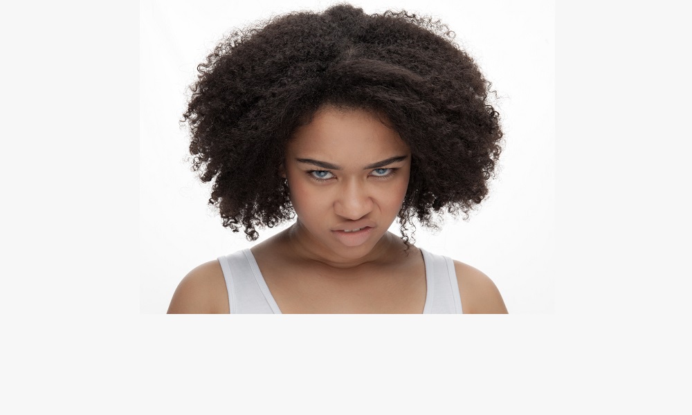 Portrait of angry young African-American teenage girl, Isolated on white background.