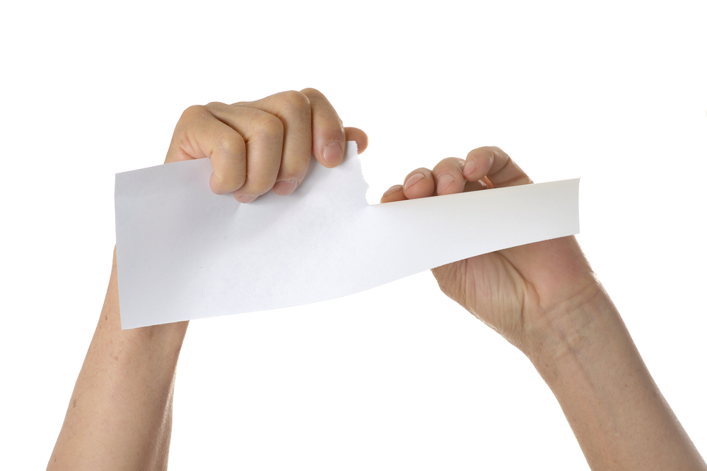 Unhelpful Social Narrative: Hands tearing paper sheet, closeup on white background