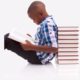 childrens-literacy-grants, young boy reading book