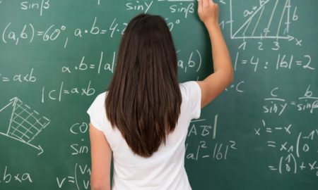 high school math summer program grants; young female student doing math on chalkboard