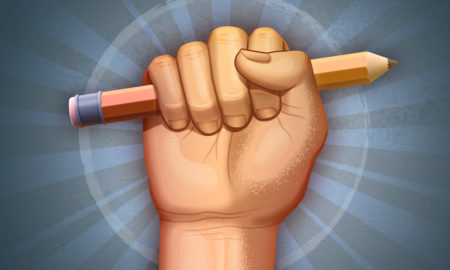 Free press: Fist holding a pencil as a symbol of freedom.