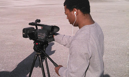 Student Reporting Labs: Young man operates videocam