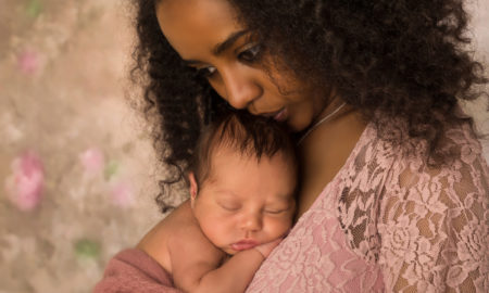 CAPTA: Beautiful African mother in pink lace dress holding her 1 week old baby