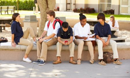 social trust: 6 students sit outside, talking to each other.