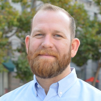 youth activists: Daren Howard (headshot), director of business development at Partnership for Children and Youth, man with beard, mustache, light blue button-down shirt