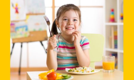 food additives child health report, young girl happy at table holding fork