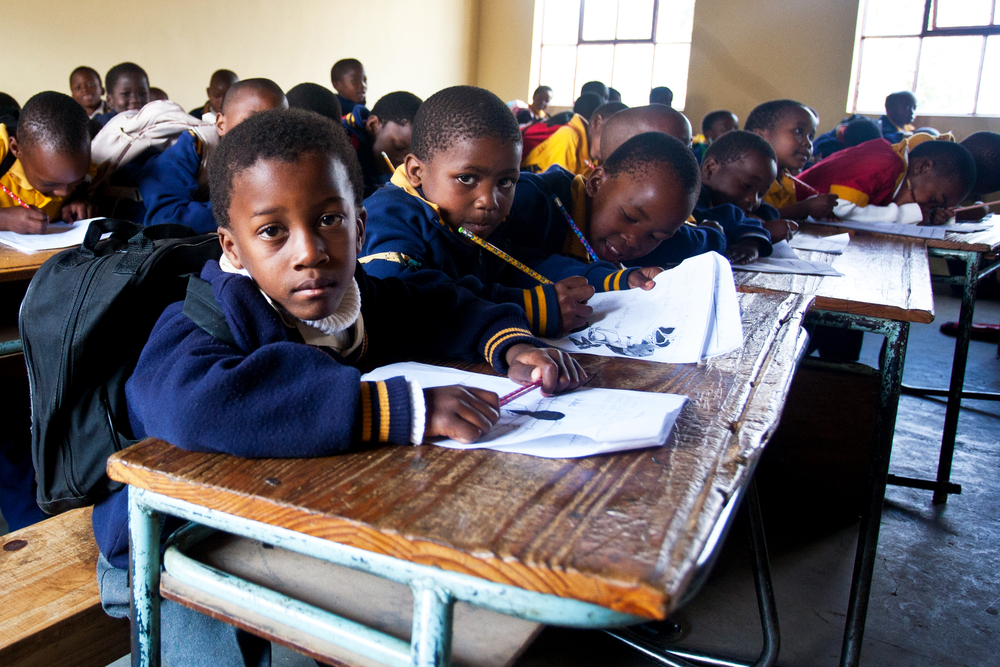 mentoring: Young boys in classroom sitting at desks in Nazarene Mission School, Piggs Peak, Swaziland