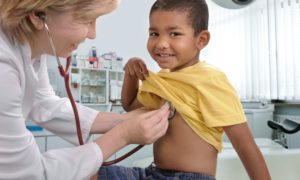 child healthcare grants; doctor examining young boy