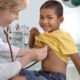 child healthcare grants; doctor examining young boy