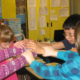 Wyoming community grants; children joining hands in classroom