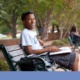 south carolina community grants; young student sitting on bench