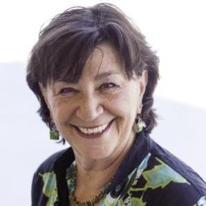 young parents: Pat Paluzzi (headshot), president and CEO of Healthy Teen Network, smiling woman with short brown hair, earrings, patterned top