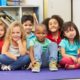 AL, GA, FL child/youth education development grants; happy children sitting on floor in classroom