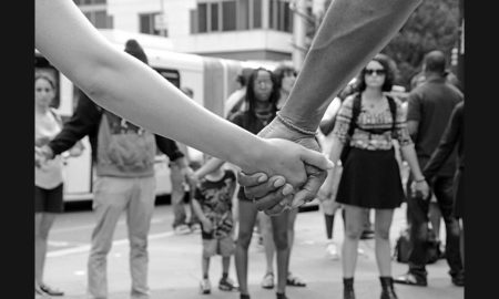 New England community social change grants; demonstrators holding hands on city street