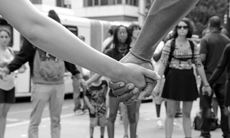 New England community social change grants; demonstrators holding hands on city street