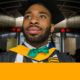 youth violence: Soulful-looking young man in graduation gown, mortarboard with beard and mustache looks off to left