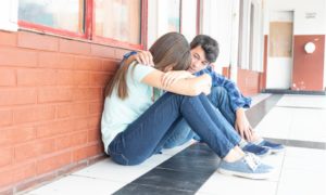 inclusion, anti-hate and anti-bullying grants; teen comforting other teen at school