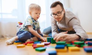 early childhood welfare and family support program grants; child and father playing on floor